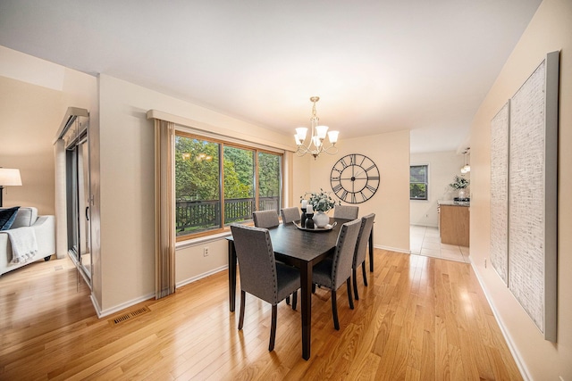 1 Northwick Ct, Ann Arbor, MI 48105 - dining space with a chandelier, light wood-style flooring, and baseboards