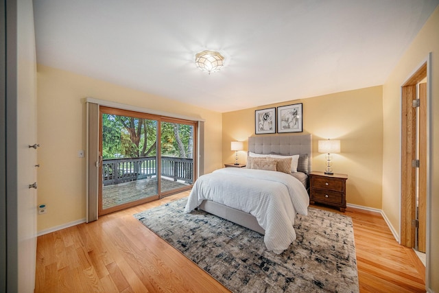 1 Northwick Ct, Ann Arbor, MI 48105 - bedroom featuring access to outside, baseboards, and light wood-style flooring