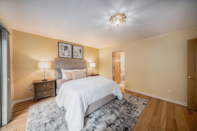 1 Northwick Ct, Ann Arbor, MI 48105 - bedroom featuring baseboards, light wood-style flooring, and connected bathroom
