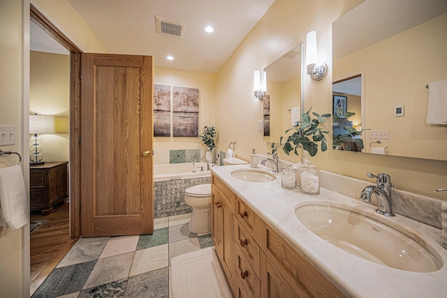 1 Northwick Ct, Ann Arbor, MI 48105 - full bathroom featuring a garden tub, recessed lighting, double vanity, and toilet