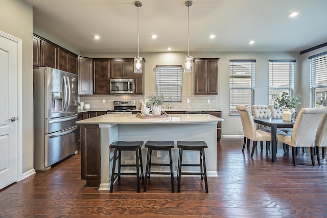 50305 Thatcher St, Canton, MI 48188 - kitchen featuring stainless steel appliances, dark brown cabinets, a kitchen island, light countertops, and recessed lighting