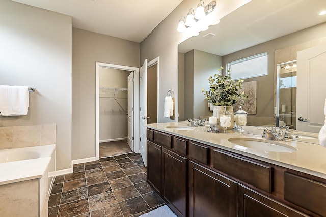 50305 Thatcher St, Canton, MI 48188 - full bath with double vanity, a bath, a shower stall, a spacious closet, and baseboards