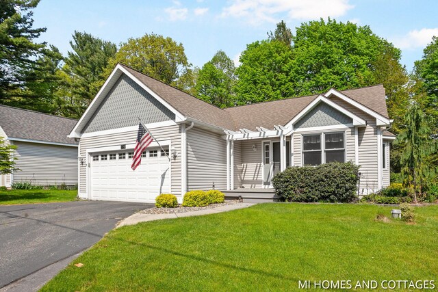 3760 Lakeshore Dr, Holland, MI 49424 - view of front of property with a garage, driveway, a front yard, roof with shingles, and covered porch