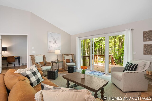 3760 Lakeshore Dr, Holland, MI 49424 - living room with vaulted ceiling, an office area, and wood finished floors