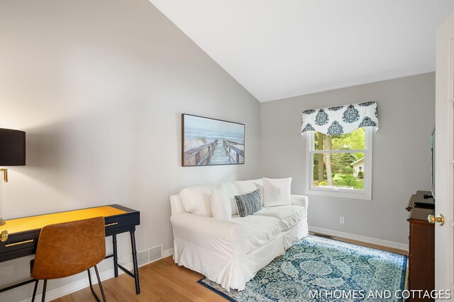 3760 Lakeshore Dr, Holland, MI 49424 - home office featuring wood finished floors, baseboards, and vaulted ceiling