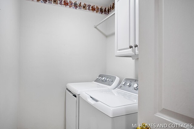 3760 Lakeshore Dr, Holland, MI 49424 - laundry room featuring cabinet space and independent washer and dryer