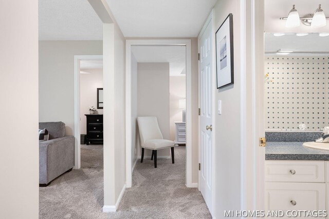 3760 Lakeshore Dr, Holland, MI 49424 - hallway featuring light carpet, a sink, and baseboards