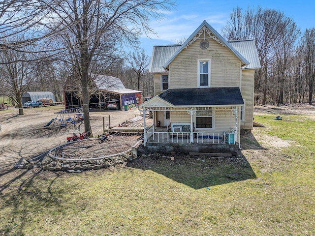 2640 Terminal St, Niles, MI 49120 - rear view of house featuring a lawn, metal roof, a porch, and a carport