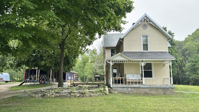 2640 Terminal St, Niles, MI 49120 - victorian home with covered porch, a front lawn, and metal roof