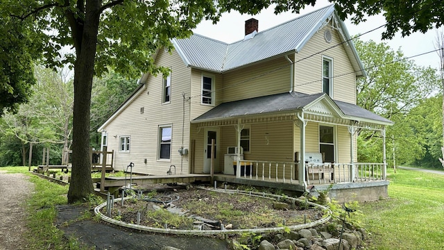 2640 Terminal St, Niles, MI 49120 - view of front of home featuring covered porch, a chimney, a front lawn, and metal roof