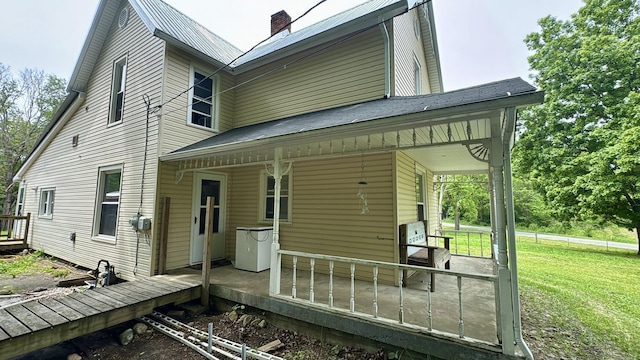 2640 Terminal St, Niles, MI 49120 - back of house featuring a chimney, a yard, and covered porch