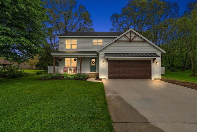 view of front of house with covered porch, concrete driveway, a front yard, and an attached garage