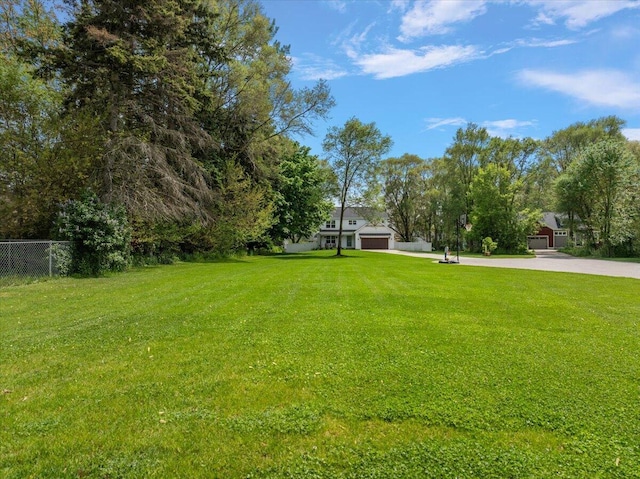 view of yard with driveway and an attached garage