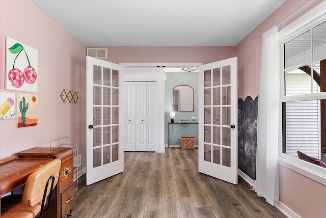 office space featuring french doors, wood finished floors, and baseboards