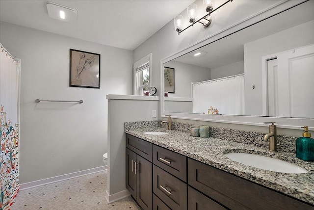 full bath with baseboards, toilet, double vanity, tile patterned floors, and a shower with curtain