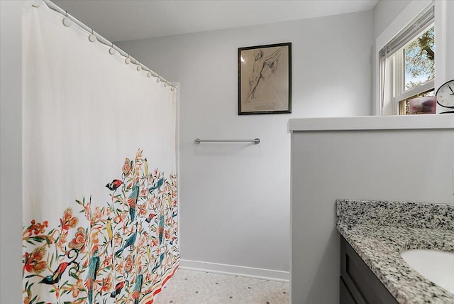 bathroom featuring vanity and baseboards