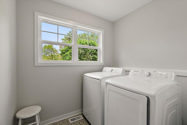 washroom featuring washer and clothes dryer and baseboards