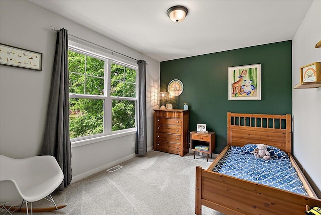 bedroom featuring carpet and baseboards