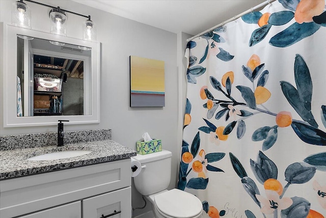 bathroom featuring vanity, toilet, and a shower with curtain