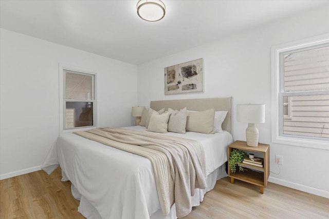 bedroom featuring light wood-style floors and baseboards