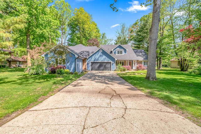 586 Schaeffer Dr, Coldwater, MI 49036 - cape cod home with an attached garage, a front lawn, and concrete driveway