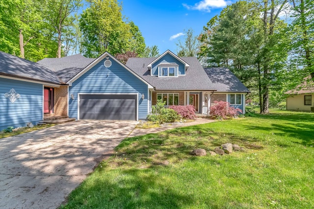586 Schaeffer Dr, Coldwater, MI 49036 - view of front of home featuring an attached garage, driveway, a front lawn, and brick siding