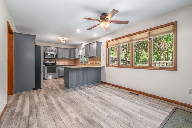 586 Schaeffer Dr, Coldwater, MI 49036 - kitchen with appliances with stainless steel finishes, gray cabinetry, a peninsula, healthy amount of natural light, and recessed lighting
