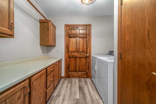 586 Schaeffer Dr, Coldwater, MI 49036 - laundry area featuring cabinet space, washer and clothes dryer, and light wood-type flooring