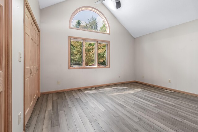 586 Schaeffer Dr, Coldwater, MI 49036 - unfurnished bedroom with light wood-style flooring, a closet, baseboards, and high vaulted ceiling