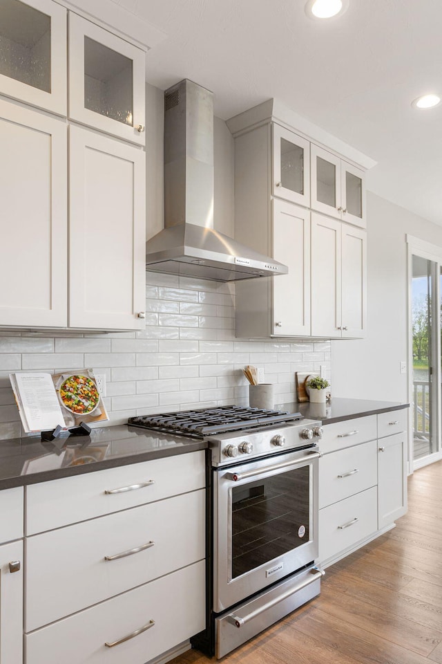 9156 Perry Ct Lot C, Lot C, Zeeland, MI 49464 - kitchen featuring gas range, wall chimney exhaust hood, dark countertops, recessed lighting, and white cabinets