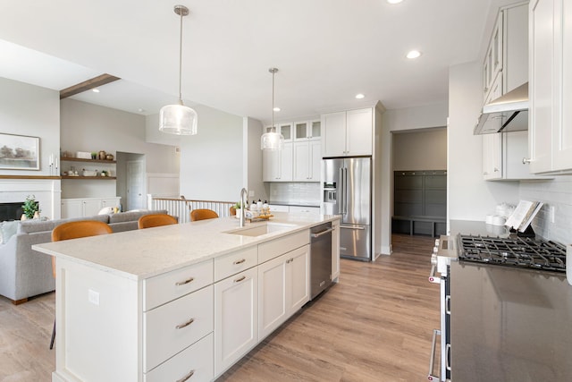 9156 Perry Ct Lot C, Lot C, Zeeland, MI 49464 - kitchen featuring a sink, under cabinet range hood, stainless steel appliances, a breakfast bar, and tasteful backsplash