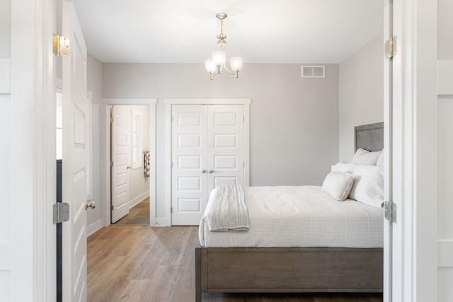9156 Perry Ct Lot C, Lot C, Zeeland, MI 49464 - bedroom with a chandelier, light wood-style flooring, a closet, and baseboards