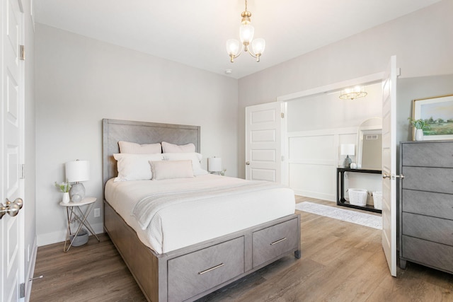 9156 Perry Ct Lot C, Lot C, Zeeland, MI 49464 - bedroom with a chandelier, light wood-style flooring, and baseboards