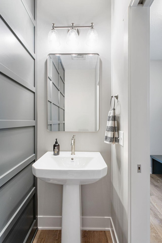 9156 Perry Ct Lot C, Lot C, Zeeland, MI 49464 - bathroom featuring wood finished floors, baseboards, and a sink