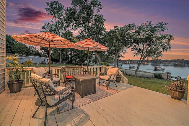 1256 Barron Lake Rd, Niles, MI 49120 - deck at dusk featuring a water view, outdoor lounge area, and a lawn
