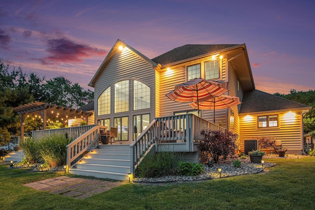 1256 Barron Lake Rd, Niles, MI 49120 - back of property at dusk with a yard, a deck, a pergola, and stairway