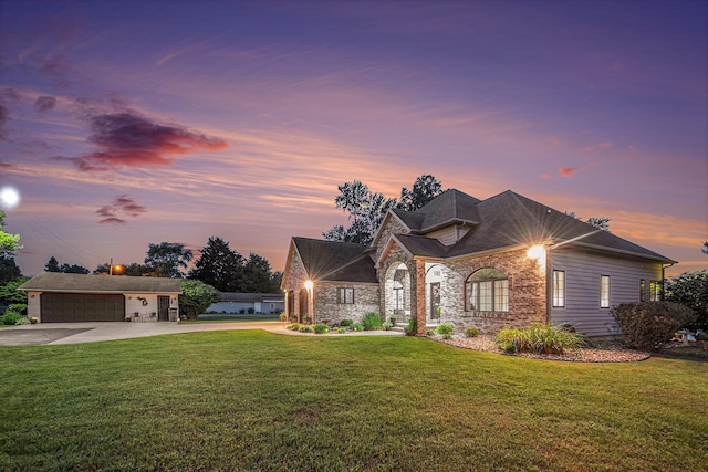 1256 Barron Lake Rd, Niles, MI 49120 - view of front of house featuring driveway, a yard, stone siding, and a garage