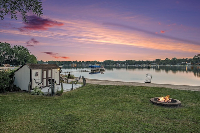 1256 Barron Lake Rd, Niles, MI 49120 - dock featuring a lawn, a water view, and an outdoor fire pit