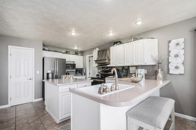 1256 Barron Lake Rd, Niles, MI 49120 - kitchen featuring appliances with stainless steel finishes, a center island, white cabinets, a peninsula, and light countertops