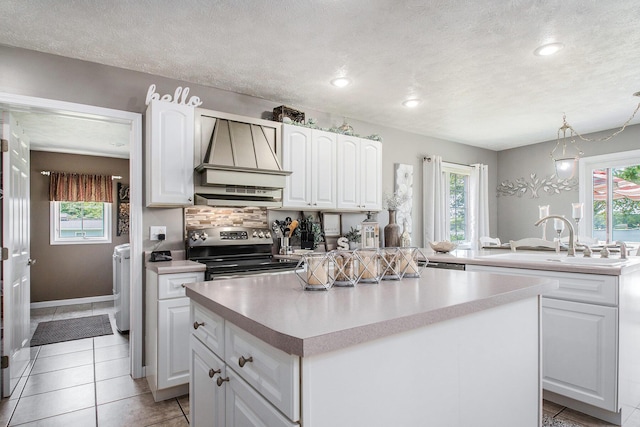 1256 Barron Lake Rd, Niles, MI 49120 - kitchen featuring electric stove, a center island, extractor fan, healthy amount of natural light, and a textured ceiling