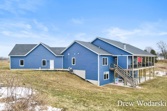 4688 20 Mile Rd, Kent City, MI 49330 - rear view of property with a deck, a shingled roof, a lawn, and stairway