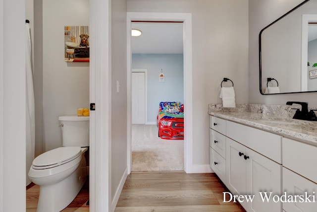 4688 20 Mile Rd, Kent City, MI 49330 - bathroom with wood finished floors, vanity, toilet, and baseboards
