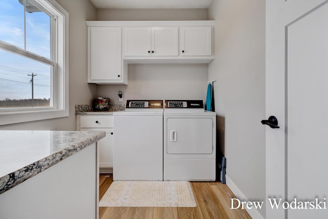 4688 20 Mile Rd, Kent City, MI 49330 - washroom with washer and clothes dryer, cabinet space, light wood-type flooring, and baseboards