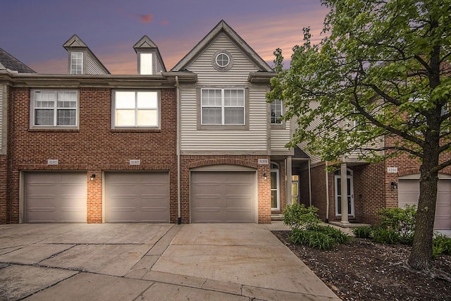 3197 Asher Rd, Ann Arbor, MI 48104 - view of front facade with driveway, an attached garage, and brick siding