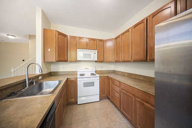 3197 Asher Rd, Ann Arbor, MI 48104 - kitchen featuring white appliances, a sink, light tile patterned floors, and brown cabinets