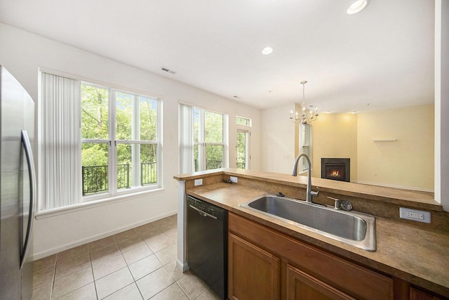 3197 Asher Rd, Ann Arbor, MI 48104 - kitchen with black dishwasher, a sink, freestanding refrigerator, baseboards, and open floor plan