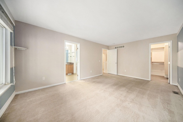 3197 Asher Rd, Ann Arbor, MI 48104 - unfurnished bedroom with a walk in closet, carpet floors, baseboards, and a closet