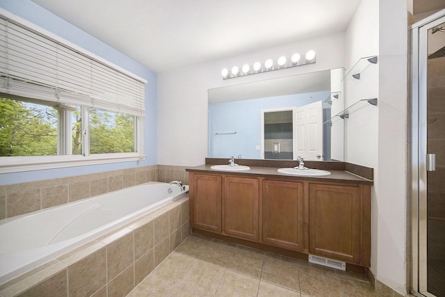 3197 Asher Rd, Ann Arbor, MI 48104 - bathroom featuring tile patterned floors, a garden tub, double vanity, and a shower stall