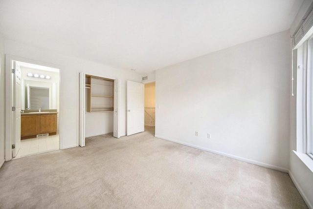 3197 Asher Rd, Ann Arbor, MI 48104 - unfurnished bedroom with light carpet, connected bathroom, baseboards, and a closet