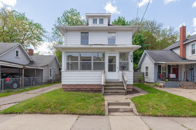 604 Edgewood St, Jackson, MI 49202 - traditional style home featuring a porch and a sunroom